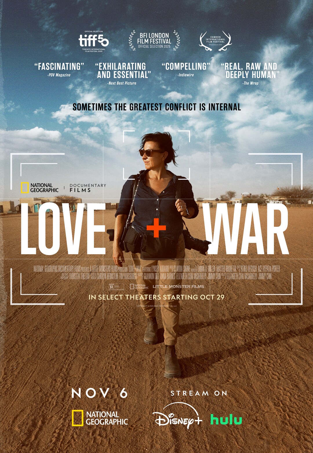 Still from Love+War showing conflict-photographer Lynsey Addario in a war zone”. Description: This documentary follows Pulitzer Prize-winning photographer Lynsey Addario as she navigates dangerous conflict zones (Middle East, Ukraine, Afghanistan) and the tension of balancing such high-risk work with family life.